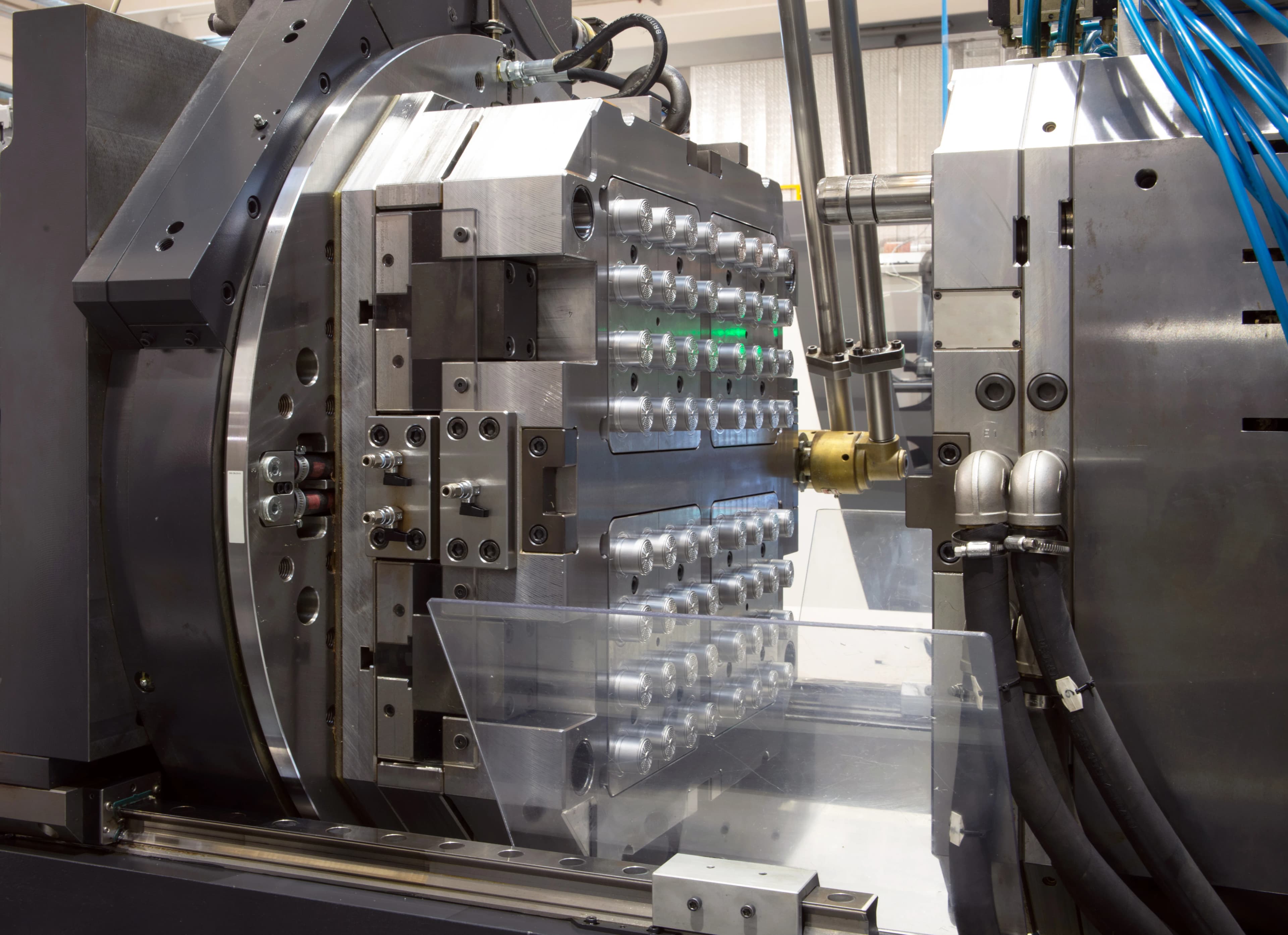 Production injection molding process manufacturing high-volume precision plastic components