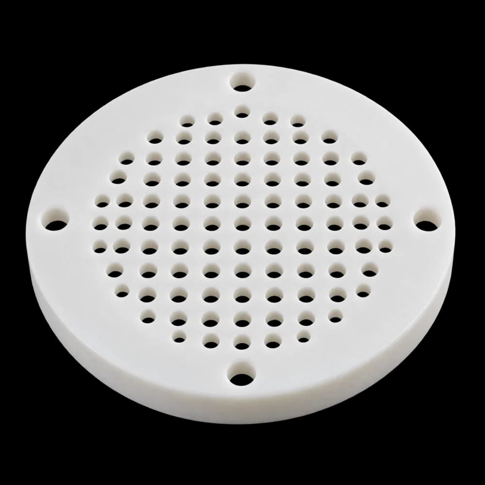 CNC milled round white polypropylene diffuser plate with a hole pattern and four mounting holes