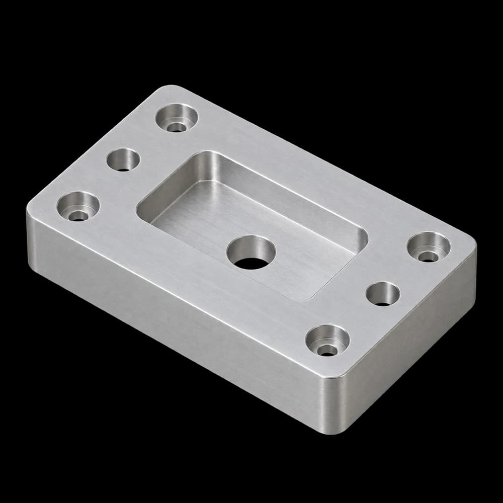 The same plate with a pocket, central bore and four additional counterbores
