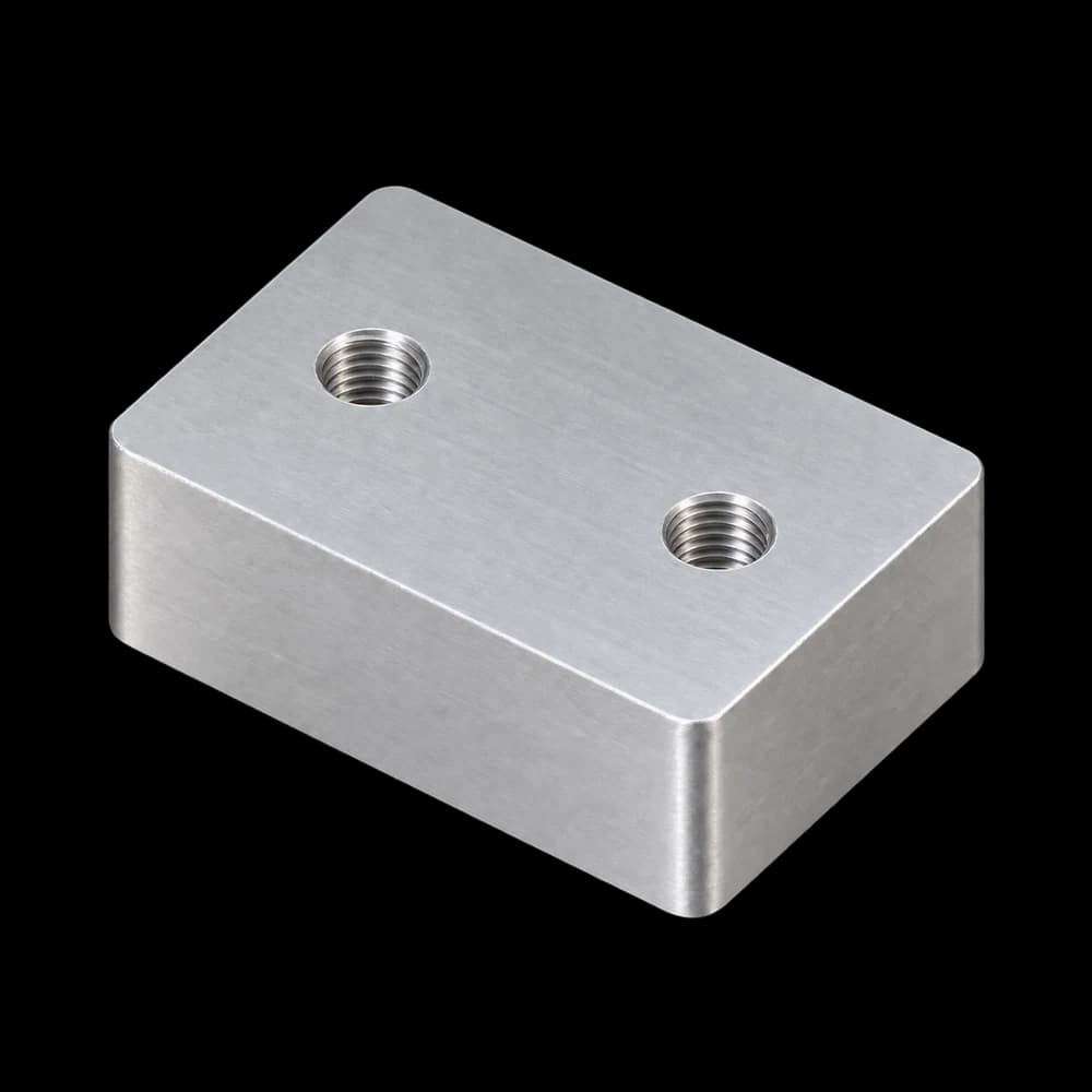 The same 6061 aluminum block with two tapped holes