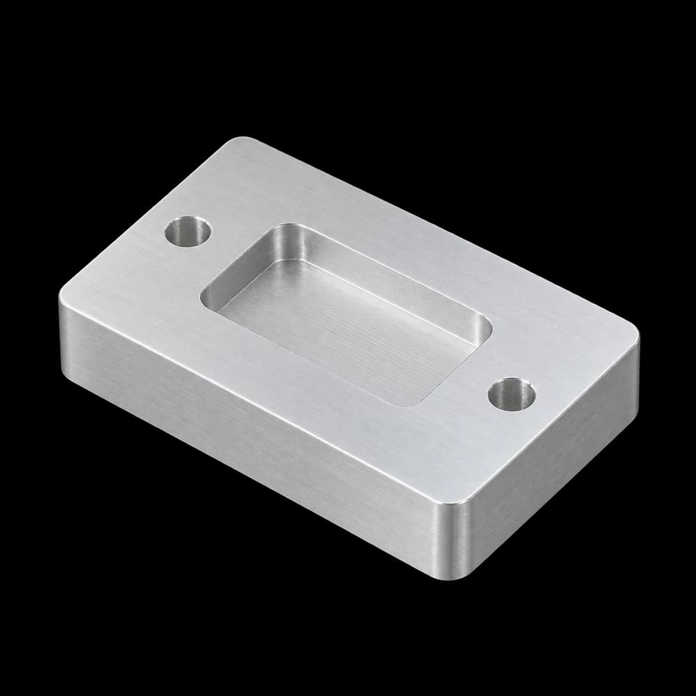 CNC-milled 6061 aluminum plate with a pocket and two holes