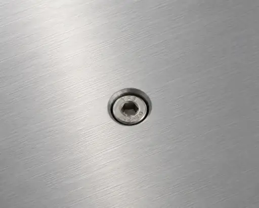 Close-up of part with inserted hardware for assembly